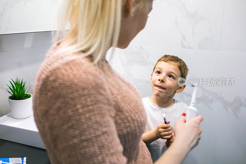 Mom teaching her son about oral hygiene